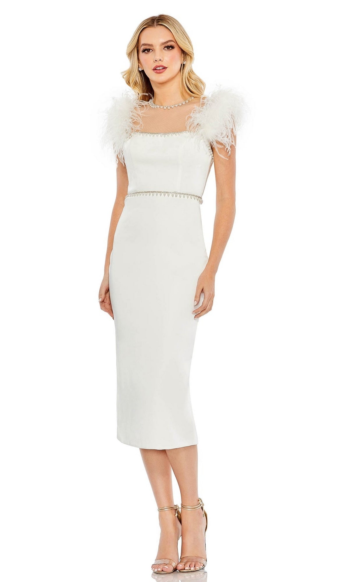 A woman in the Mac Duggal 11438 Sheer High-Neck Wedding-Guest Dress, a white, knee-length fitted silhouette with feathered shoulders and a high neckline, paired with gold strappy heels.